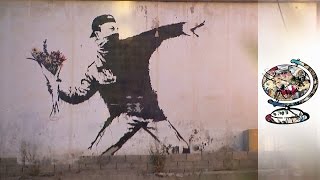 Banksys Murals Left Trail Of Conflict In Palestine [upl. by Nnylav274]